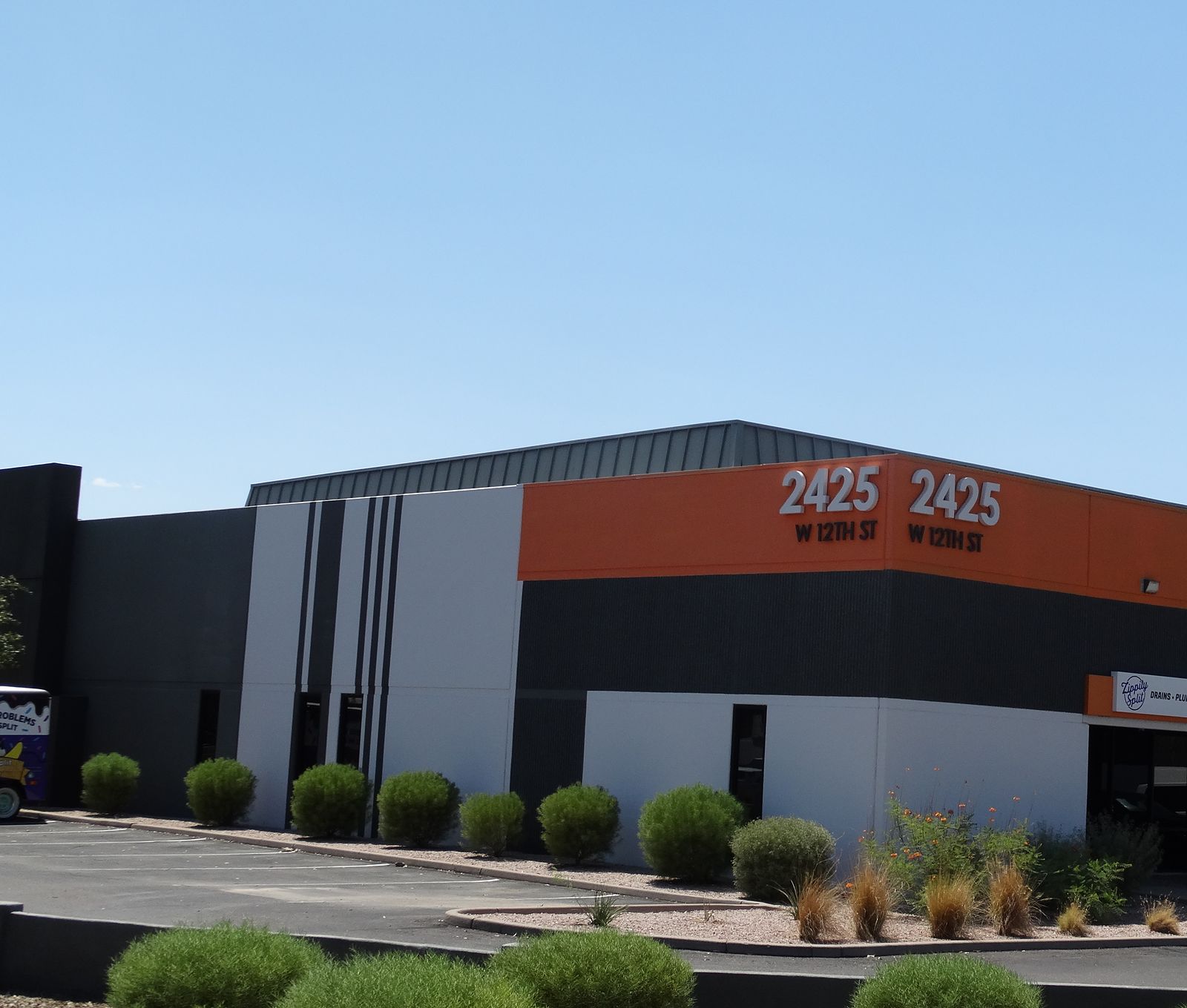 Commercial building with a finished charcoal, white, and orange exterior