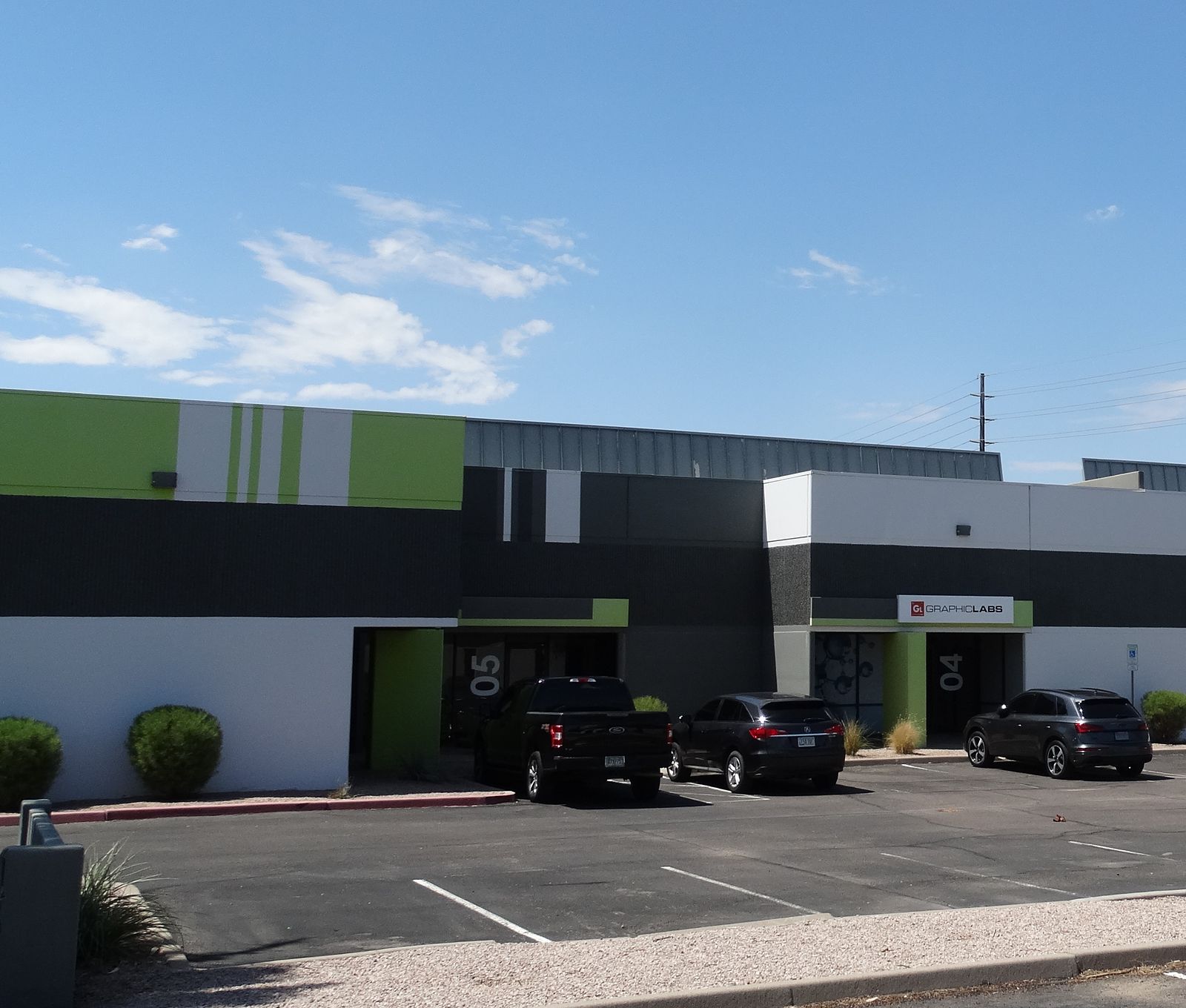 Office and flex building with a finished charcoal, white, and green exterior