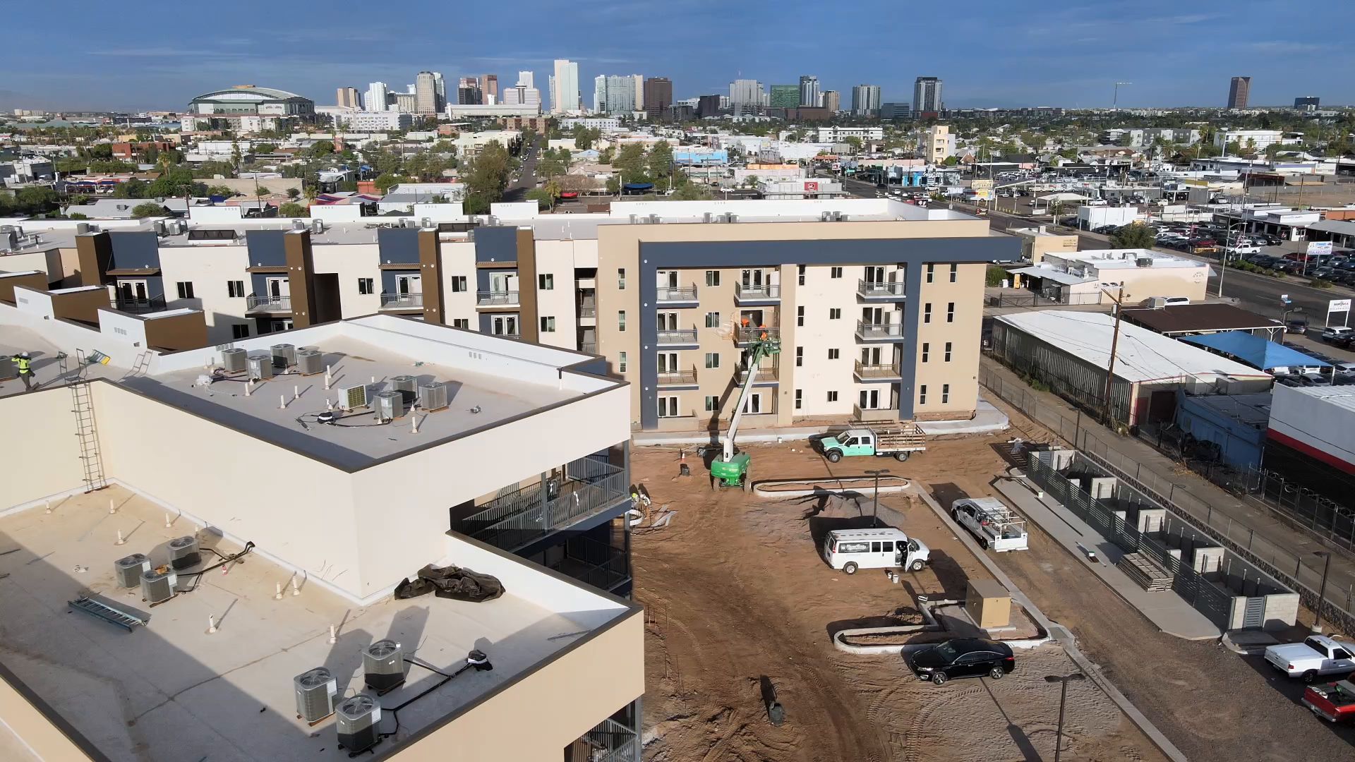 Sydney P. Osborn 1, a four-story tan and navy apartment building near downtown Phoenix with a boom lift on site