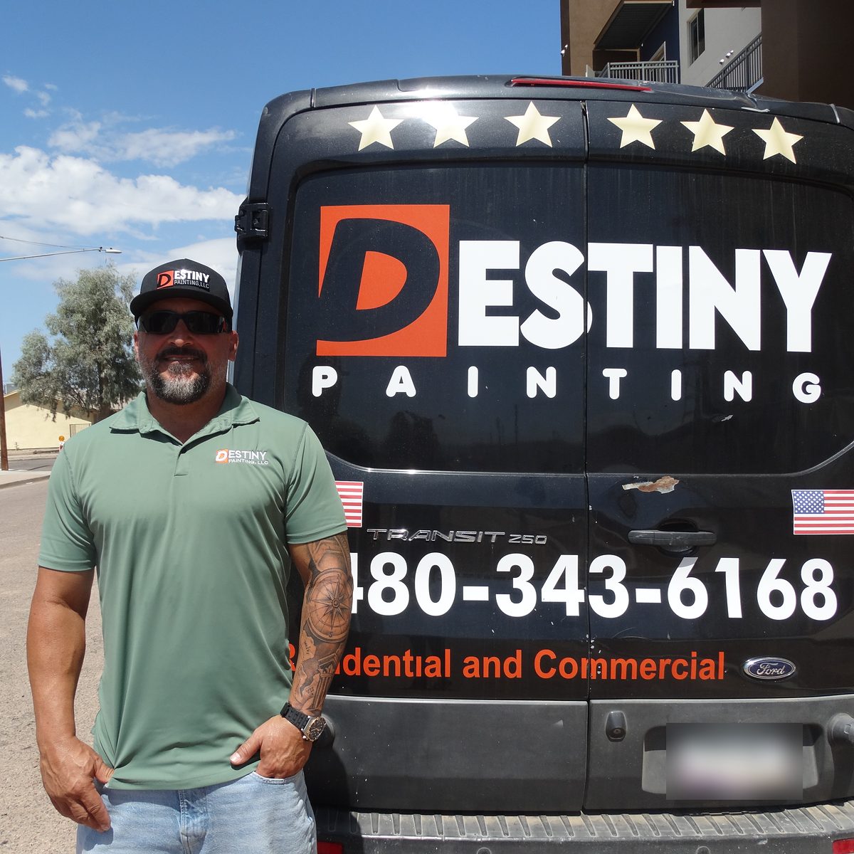 Jonathan Romero, owner of Destiny Painting, standing next to a Destiny Painting van at a job site