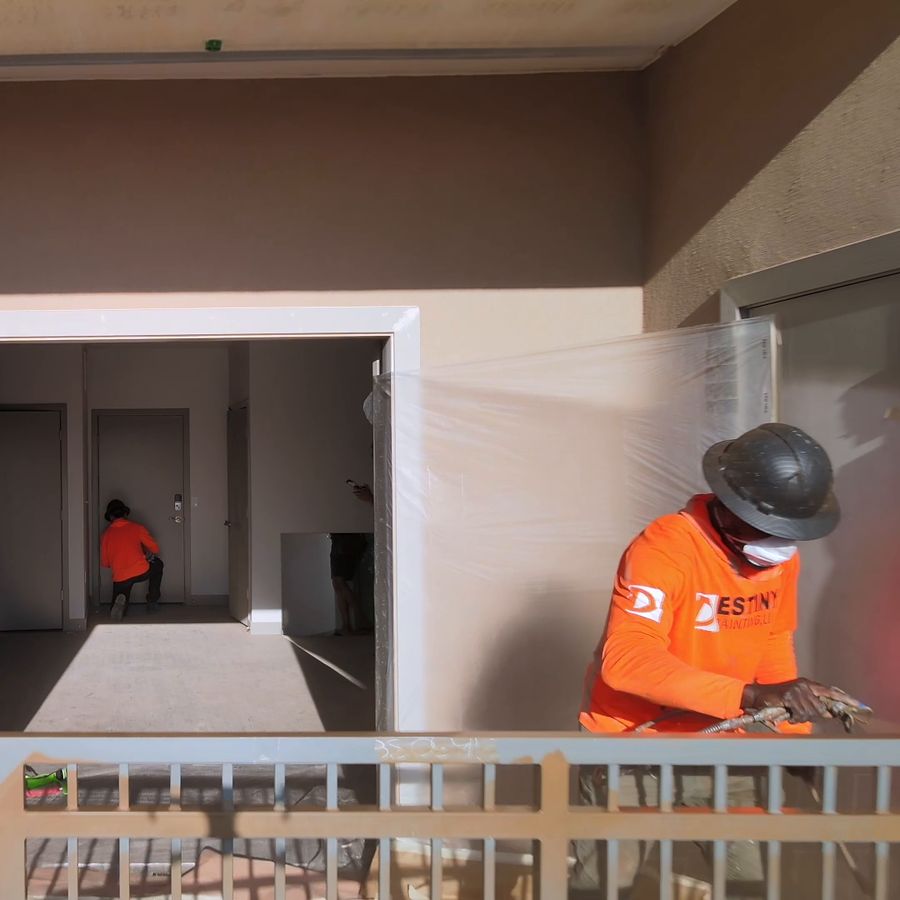 Destiny painter prepping a balcony opening with masking in place